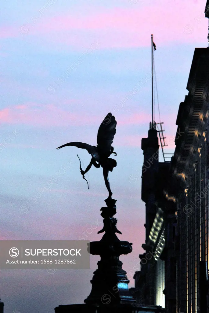 Statue of Eros in Piccadilly Cicus, seen looking westwards down Piccadilly, against a pleasant sunset, on a Spring evening in London, England.