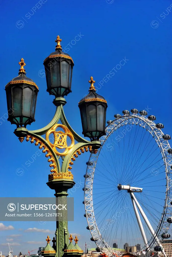 Victorian gaslamps from the 1840's (inscribed with a V&A for Victoria and Albert) on Westminster Bridge by the Houses of Parliament on a bright Spring...