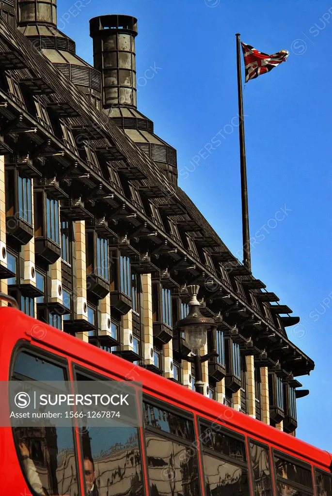 Red London bus passing Portcullis House, next to Westminster Bridge, (this is the annexe of the Houses of Parliament across the road ), on a very sunn...