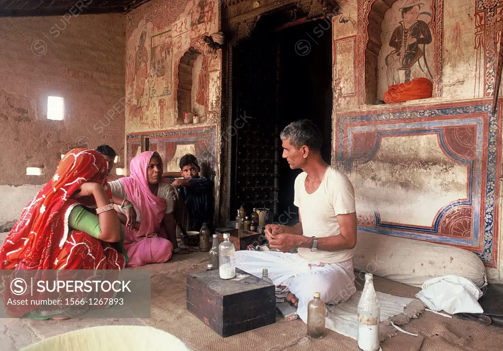 Ayurvedic doctor with patients. Shekhawati region, Rajasthan, India.