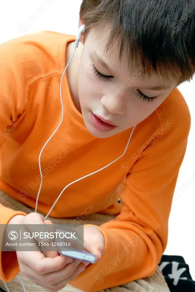 Boy listening to music on an iPod MP3 player.