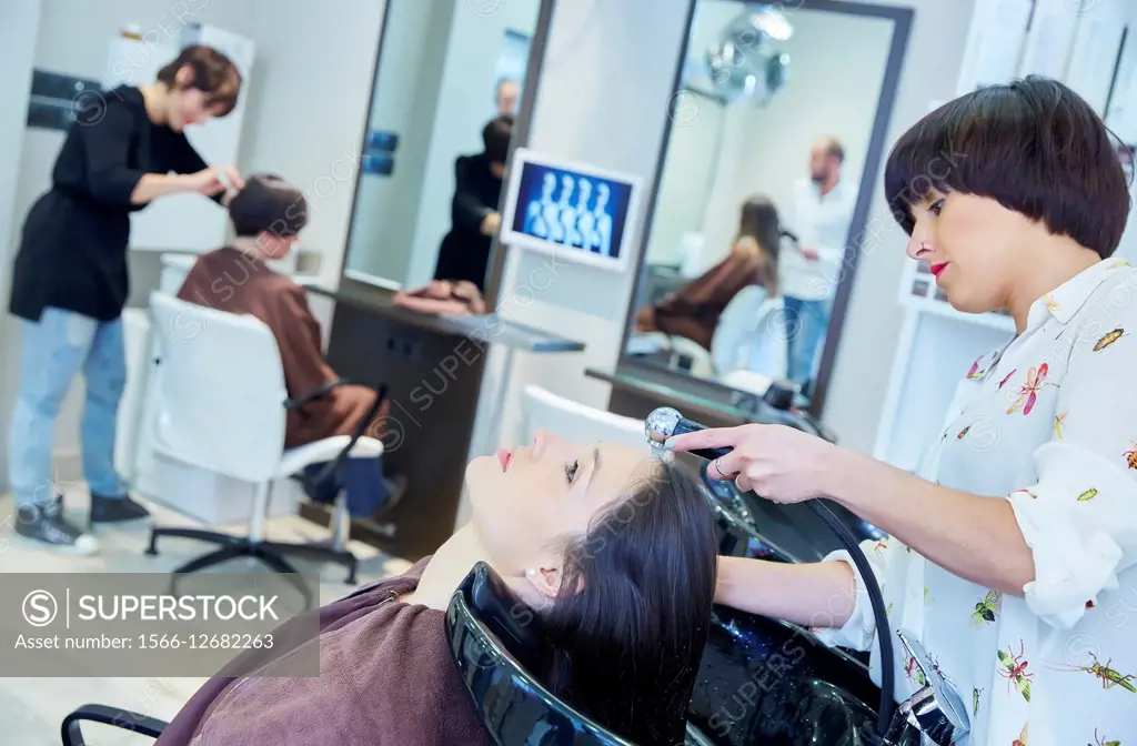 Hairdresser washing hair of a woman. Hairdressers and Beauty Clinic. Hair salon.