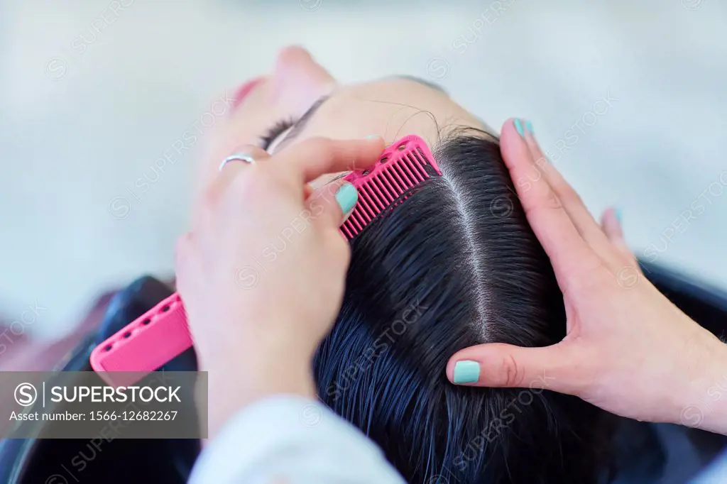 Hairdresser marking the hair of a woman. Hairdressers and Beauty Clinic. Hair salon.