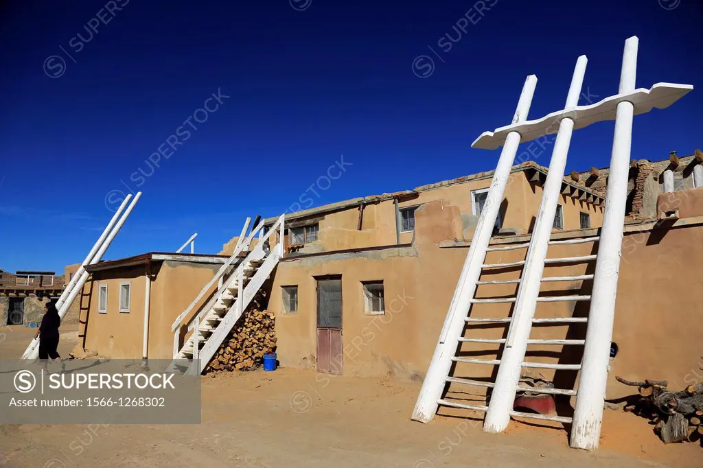 A wooden ladder leads to the second story entrance of a Kiva a religious contemplation chamber in the house in Acoma Pueblo aka Sky City. Acoma Pueblo...