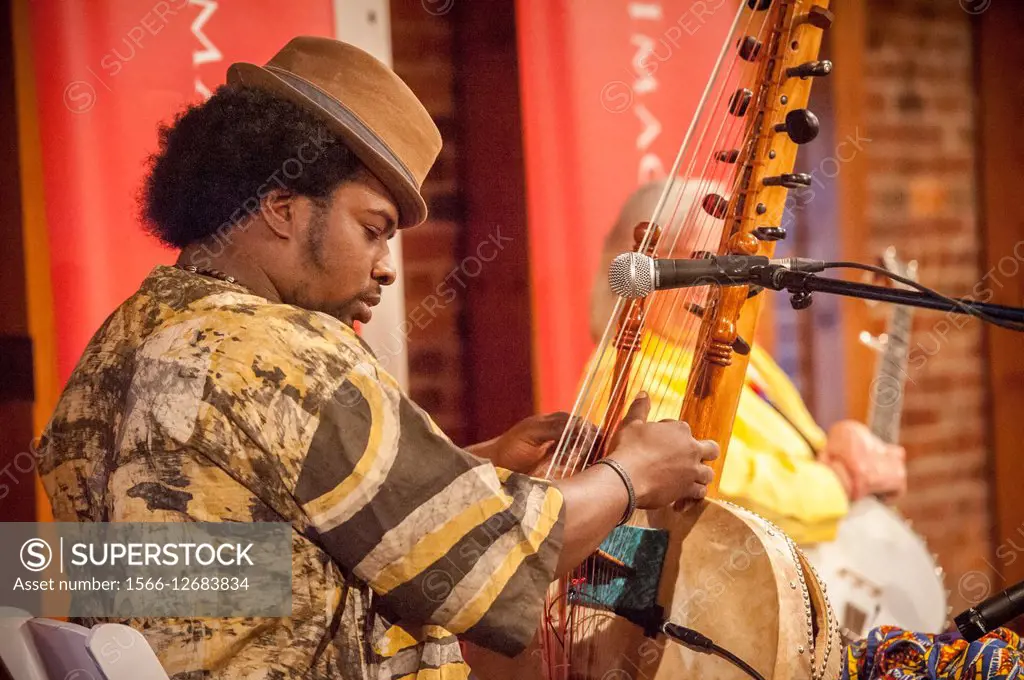 African American man playing a Kora musical instrument in Baltimore, Maryland, USA.