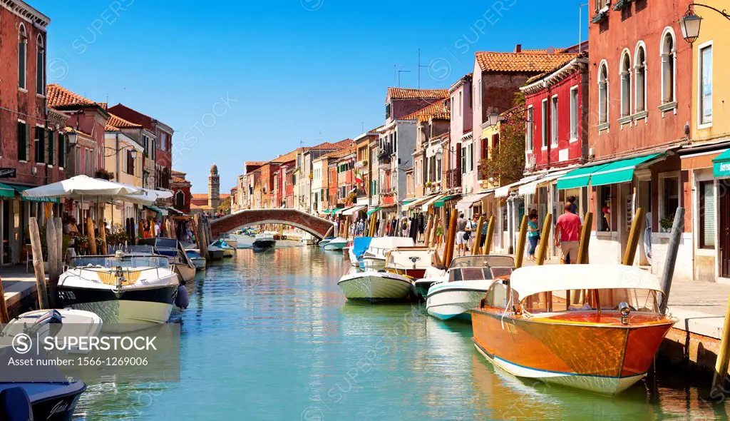Murano - canal of Fondamente dei Vetrai with boats moored on quay and bridge over canal, Murano Island, Italy.
