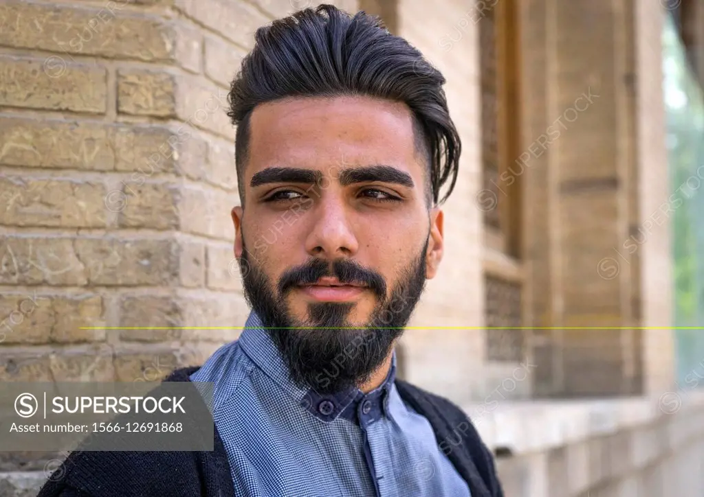 Iran, Isfahan Province, Isfahan, young man with western haircut in the bazaar.