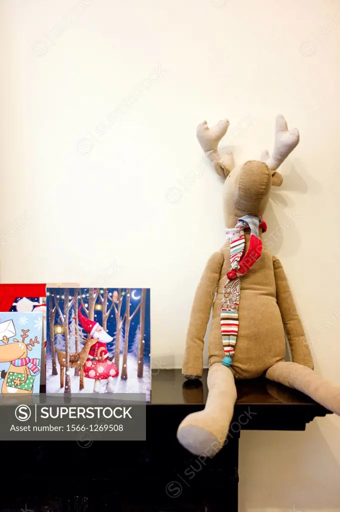 Shelf with Christmas atmosphere with cards and a rag doll Rudolf
