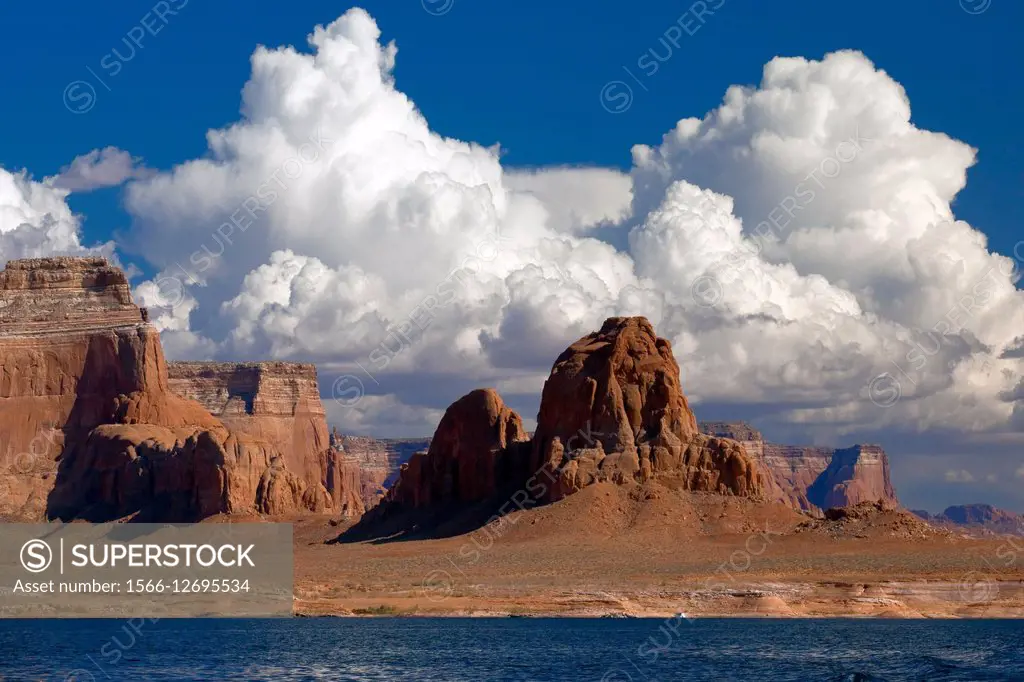 Red rock buttes and clouds on the shores of Lake Powell, Utah.