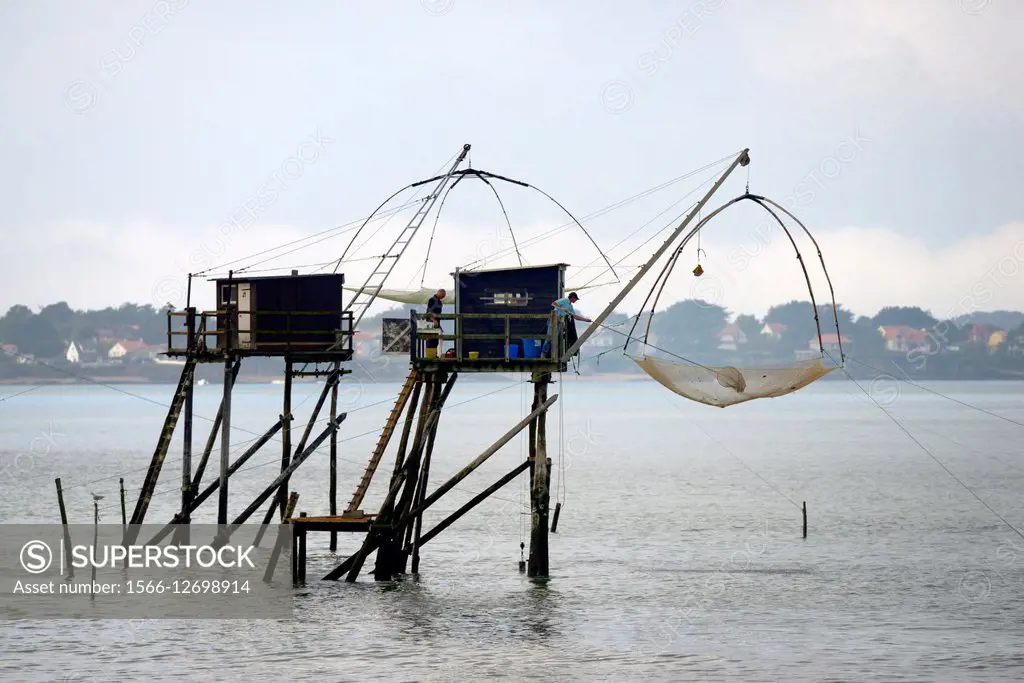 Traditional carrelet lift net fishing hut. Saint-Michel-Chef-Chef beach,  Loire-Atlantique, France. Plaice smelt squid sole eel. - SuperStock