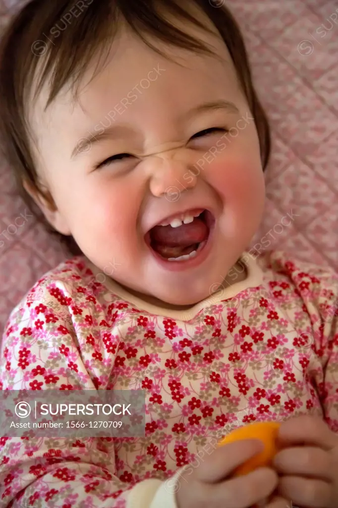 One year old girl making a funny face