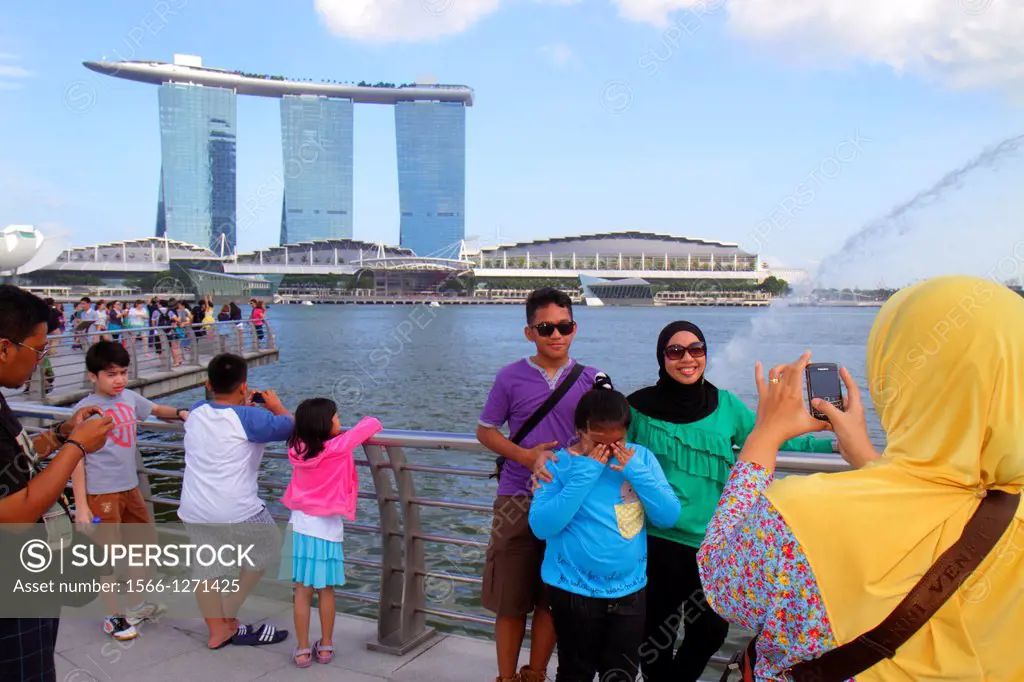 Singapore, Singapore River, Marina Bay, Merlion Park, Asian, man, woman, posing, taking picture, camera, Muslim, hijab, Marina Bay Sands Integrated Re...
