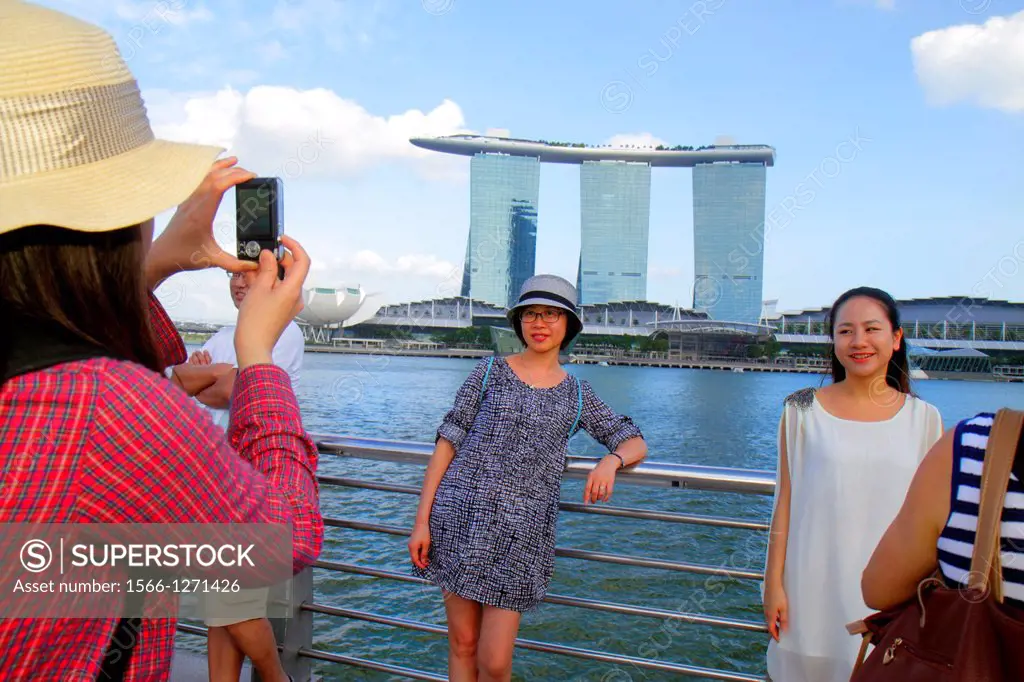 Singapore, Singapore River, Marina Bay, Merlion Park, Asian, woman, posing, taking picture, camera, Marina Bay Sands Integrated Resort, Skybridge, The...