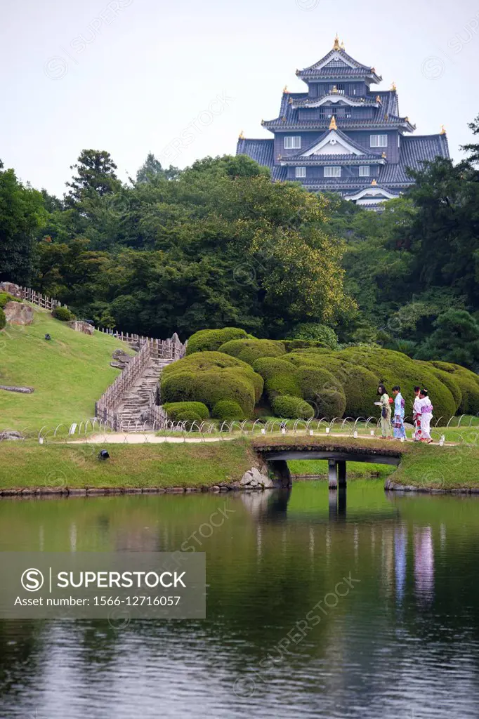 Japanese young women with typical kimono in Kagoshima castle gardens, Japan