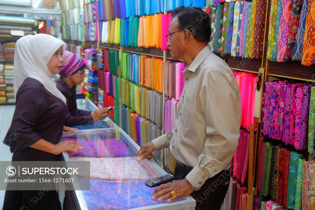 Singapore, Kampong Glam, Muslim Quarter, Arab Street, textile, merchant, fabric, business, for sale, display, Asian, man, woman, Muslim, hijab, shoppi...