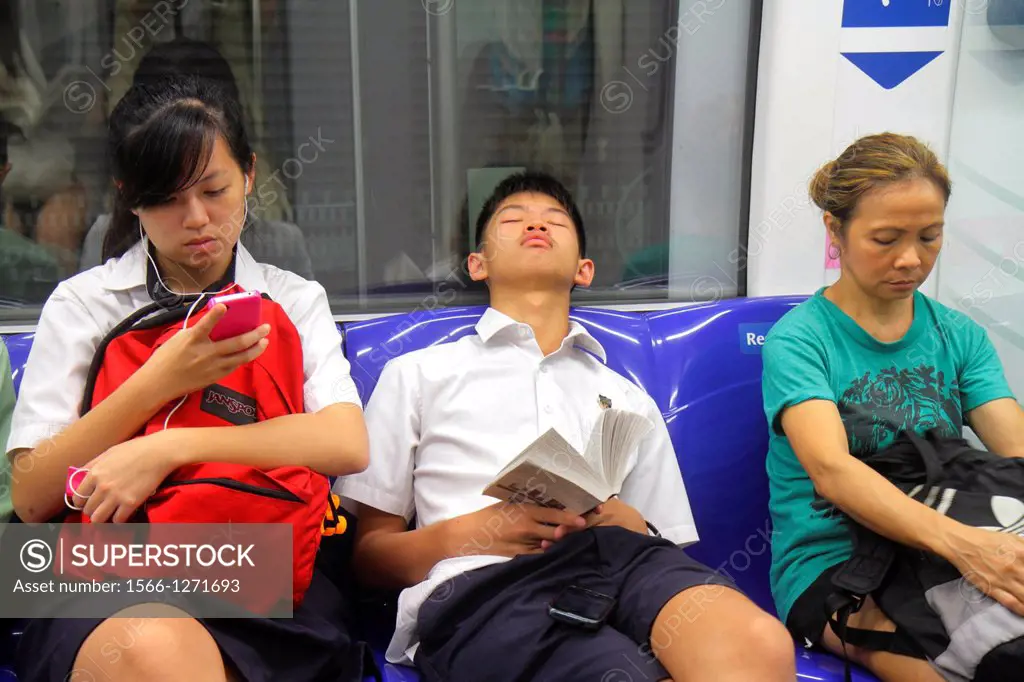 Singapore, Bishan MRT Station, Circle Line, subway train, public transportation, riders, commuters, Asian, student, teen, boy, dozing off, nodding, gi...