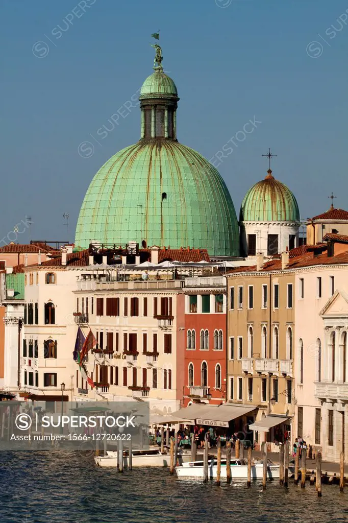 View from the Constitution Bridge at buildings at the Grand Canal with dome of the church of San Simeone Piccolo in background in Venice, Italy