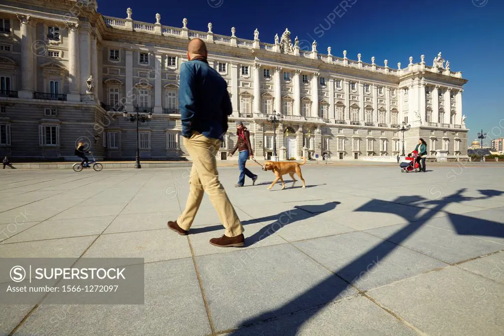 People walking along the Royal Palace. Madrid. Spain