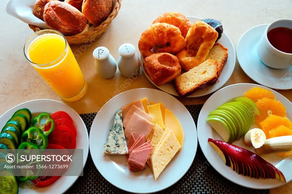 Food: breakfast with vegetables, orange juice, bread, cheese and luncheon meat, pastries, fruits and tea