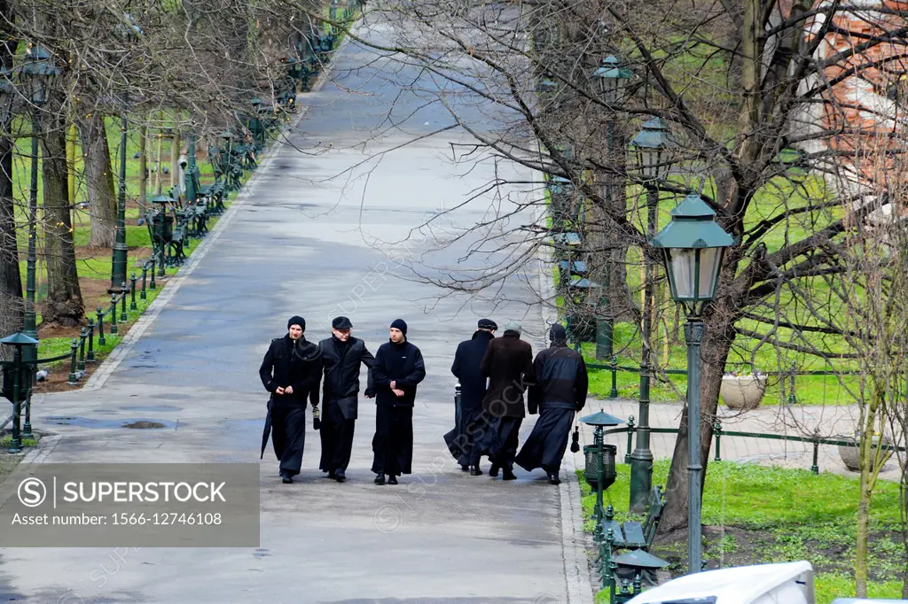 Priests walking in the Planty Park. Krakov, Poland, Europe.