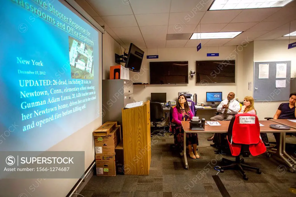 A college campus police chief in Irvine, CA, lectures administrators on safety procedures to prevent workplace violence. Note information on screen.A ...