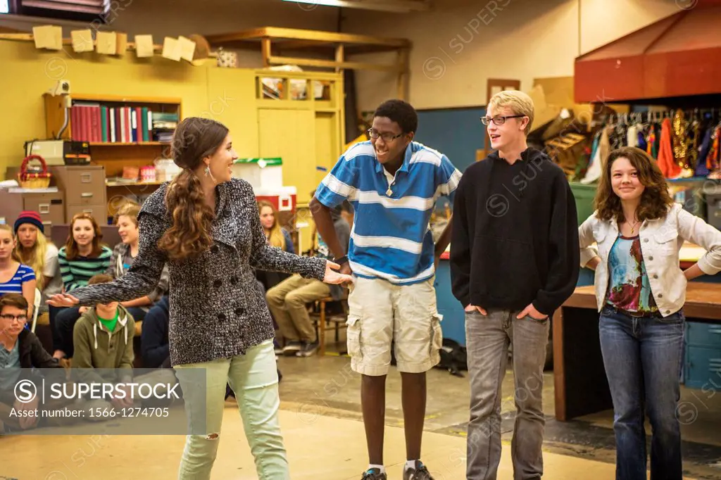 As their multiethnic classmates watch, high school drama drama students perform improvisational theatre in San Clemente, CA. Improv is a form of theat...