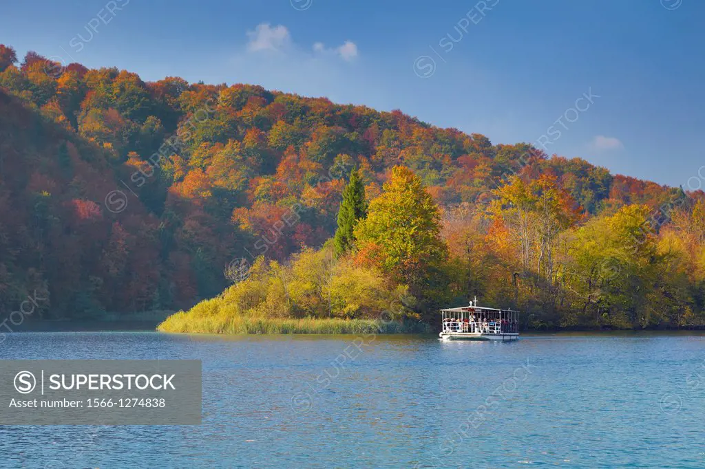 Croatia - autumn landscape of Plitvice Lakes National Park, electric power ferry boat on the lake, Plitvice, central Croatia.