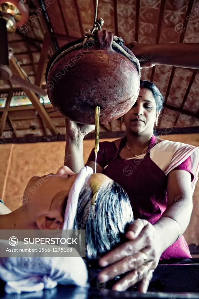 woman ayurveda traditional indian oil head massage.