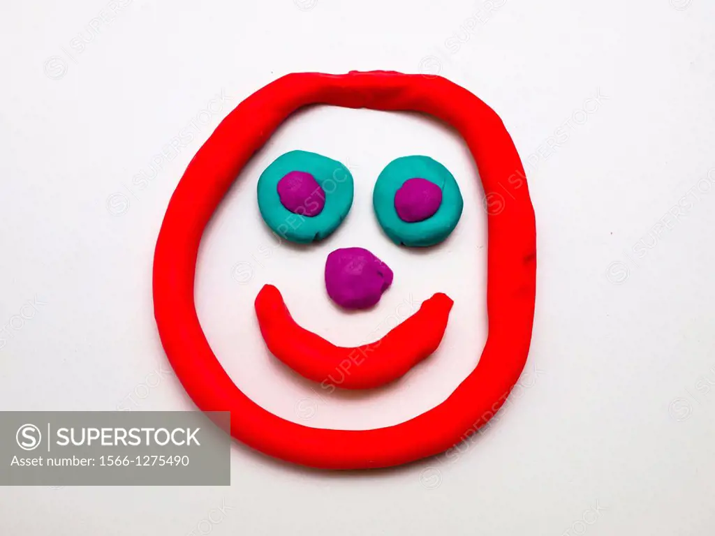 Plasticine face on a white background, made by Emiliana, nine year old girl.