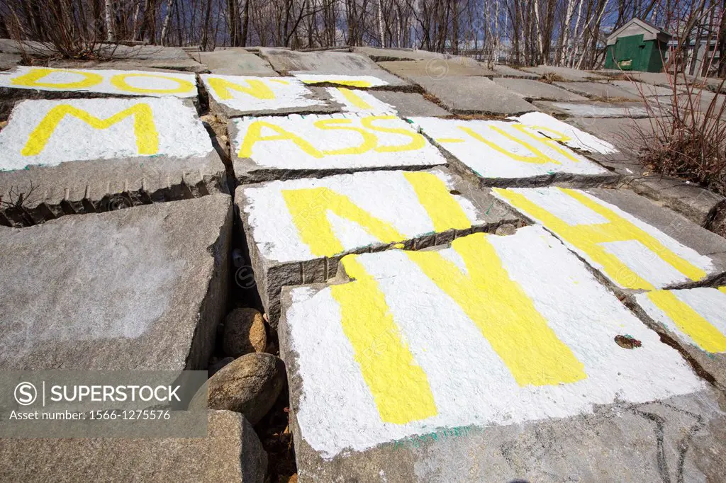 """""Don't Mass-Up NH"" spray painted on granite blocks along the East Branch of the Pemigewasset River during the spring months in Lincoln, New Hamps...