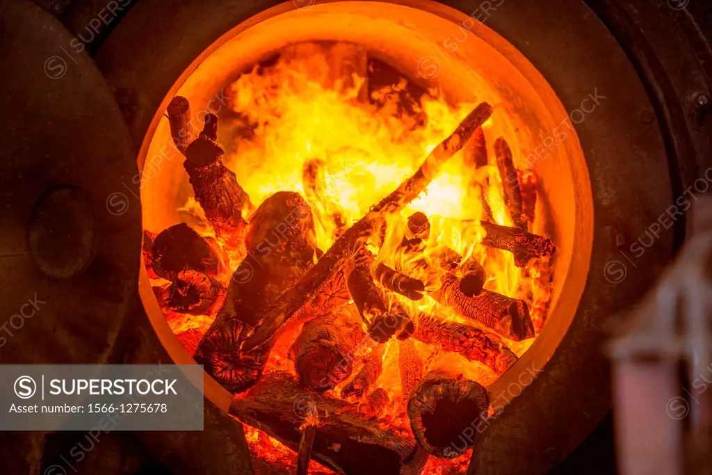 Wood burning in a stove for canola oil (rapeseed) production at Molinera Gorbea, a grain processor involved in the manufacture of fish food in Temuco,...