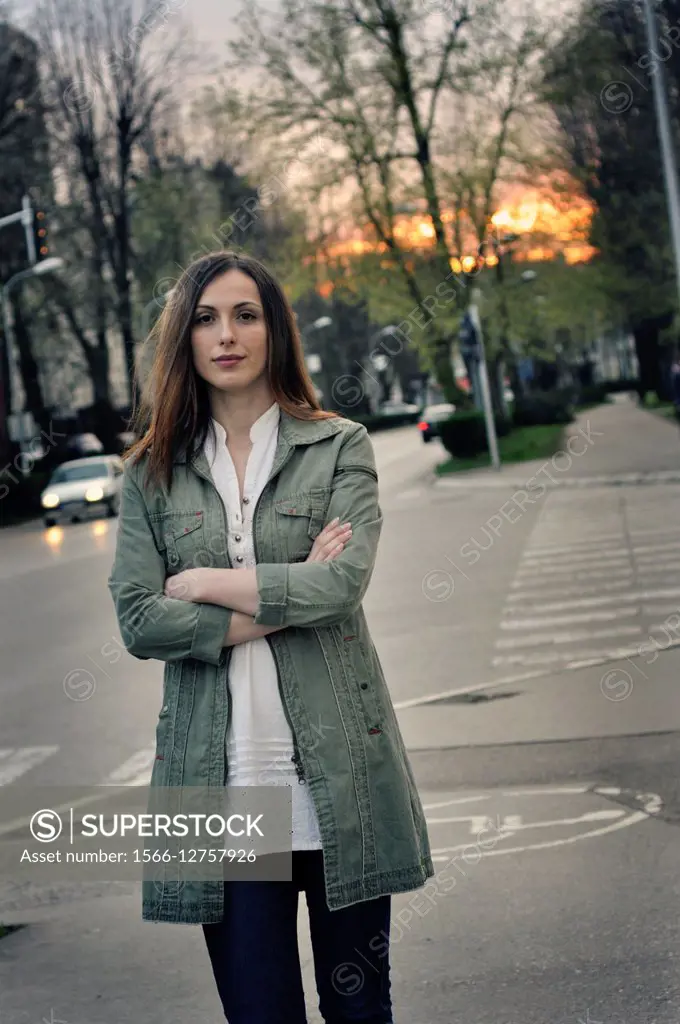 Portrait of a young woman on city street.