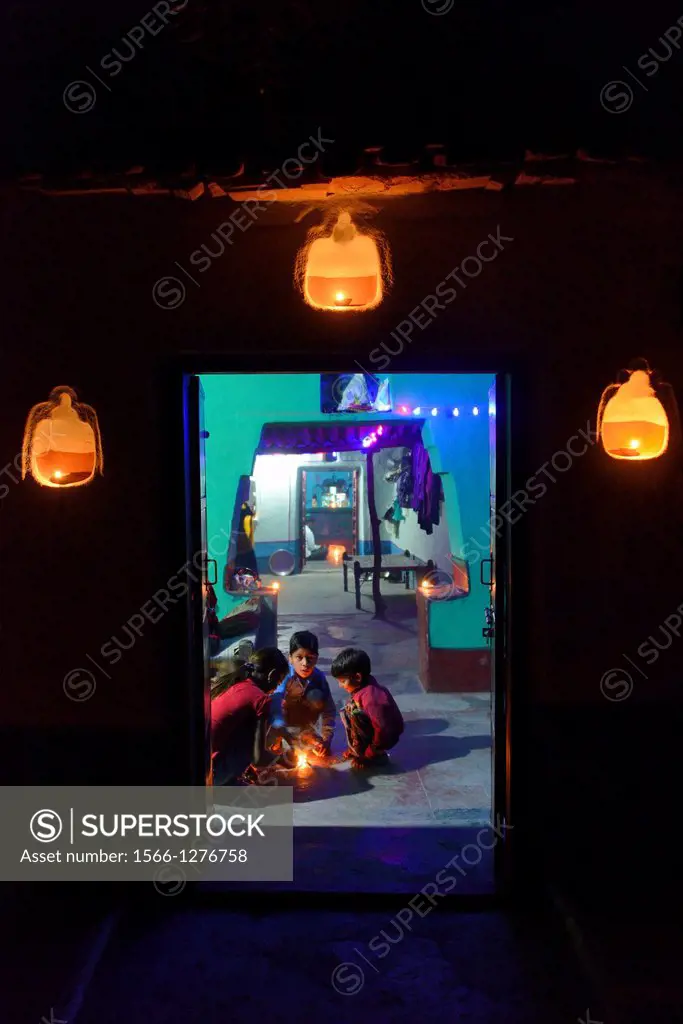 India, Rajasthan, Tonk region, Balopa village, Diwali festival, Lakshmi puja, Children lighting oil lamps to welcome goddess Lakshmi.