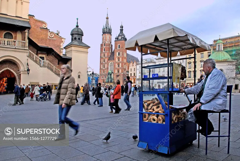 peddler selling bread rolls called Obwarzanek, Main market square, Krakow, Poland, Central Europe