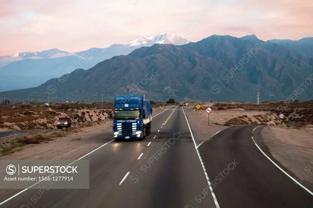 A heavy transport truck on a modern road in Uco valley, a key wine growing region, Mendoza, Argentina. Often called Argentina's NAPA valley, the Andes...