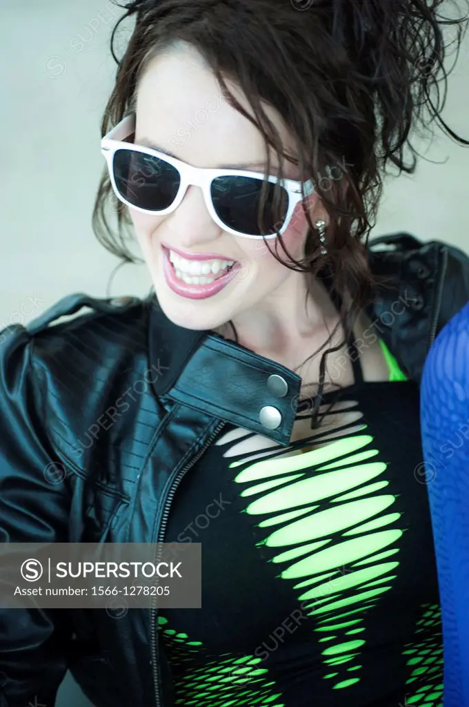A 24 year old brunette woman in with white rimmed sunglasses.
