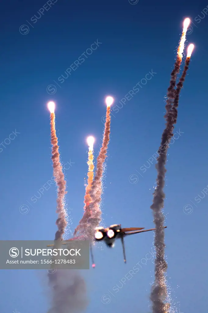 Israeli Air force F-15I Fighter in flight Emitting anti-missile flares.