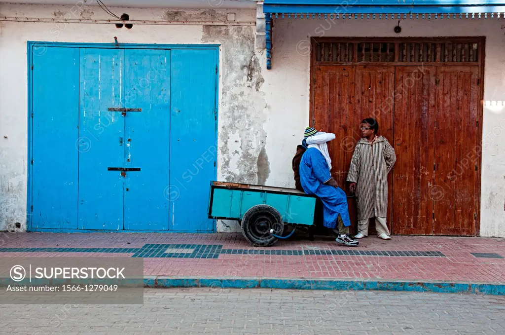 Men talking on the streets of Essaouira medina, Morocco.