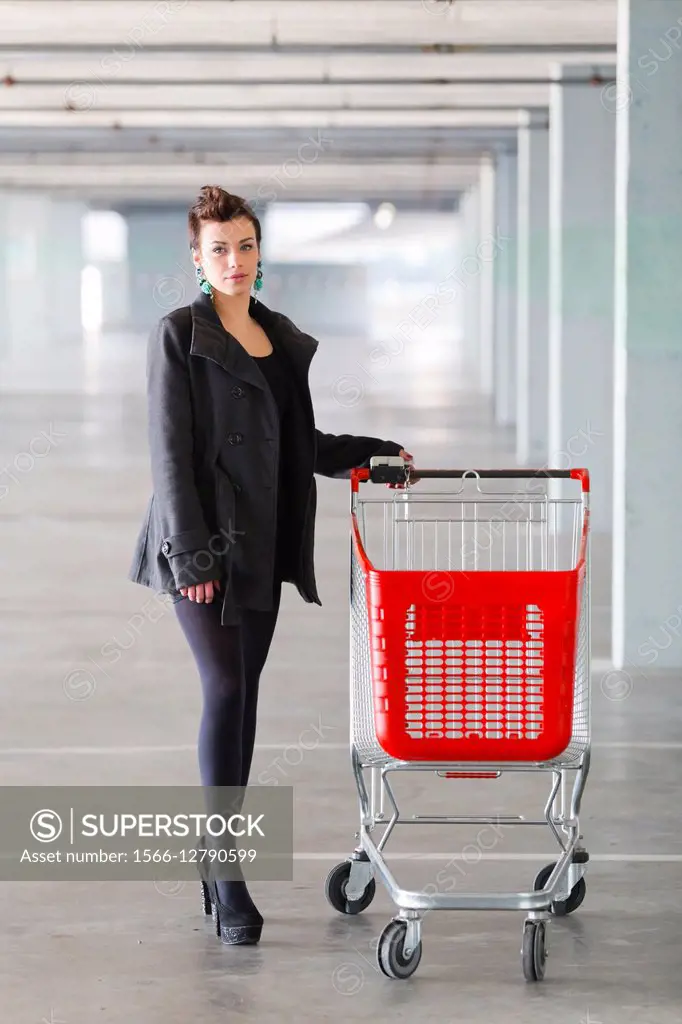 Young woman shopper with empty cart