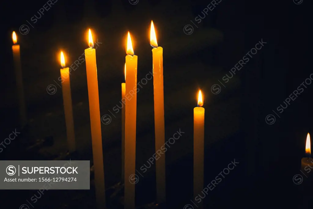Burning candles in a church in Italy. Europe