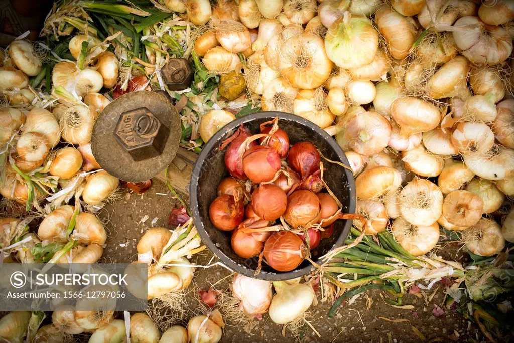 Close-up of ecological onions, an old scales and a weight of 2 kilos in the street market in Fez Medina, Morocco Africa