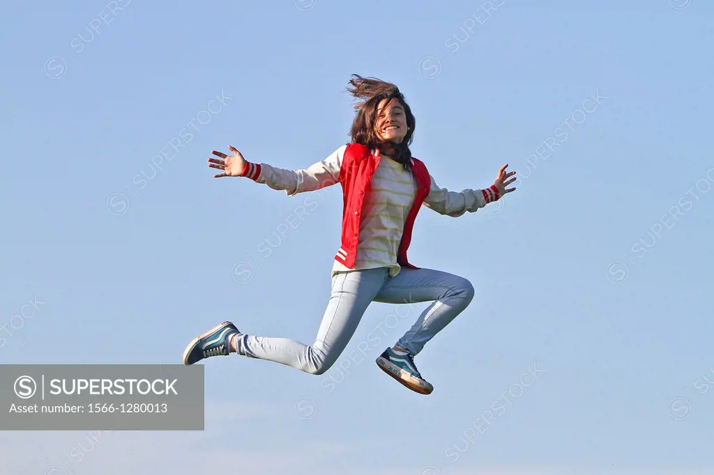 Young girl jumping in air, Spain.