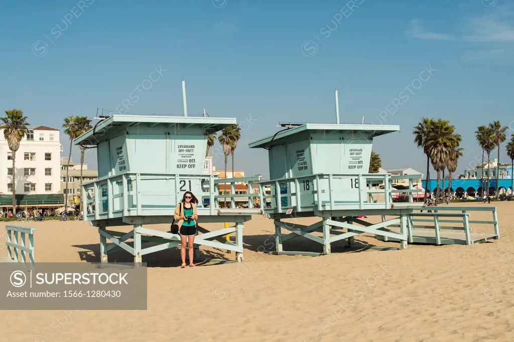teenage girl in front of lifeguard station on Venice Beach, Los Angeles, California, USA