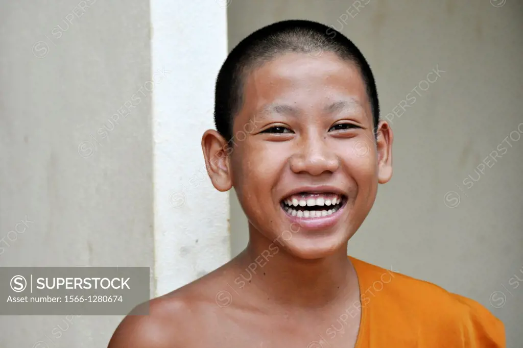 Portrait of a smiling young Buddhist priest in Vang Vieng, Laos.