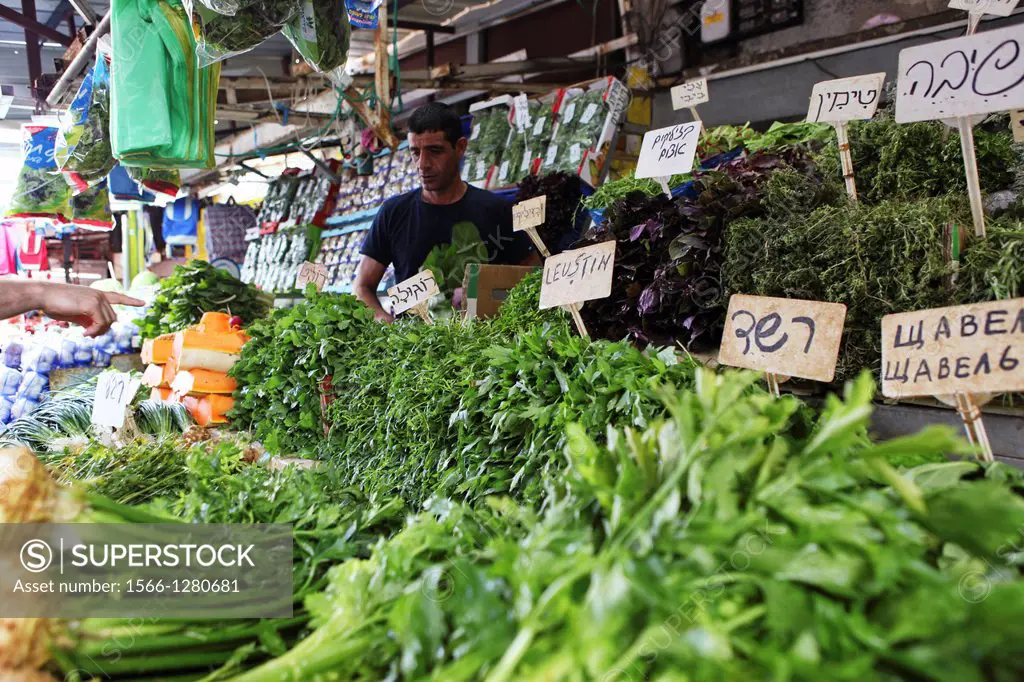 Stall selling fresh herbs and greens Photographed at the Carmel Market, Tel Aviv, Israel.