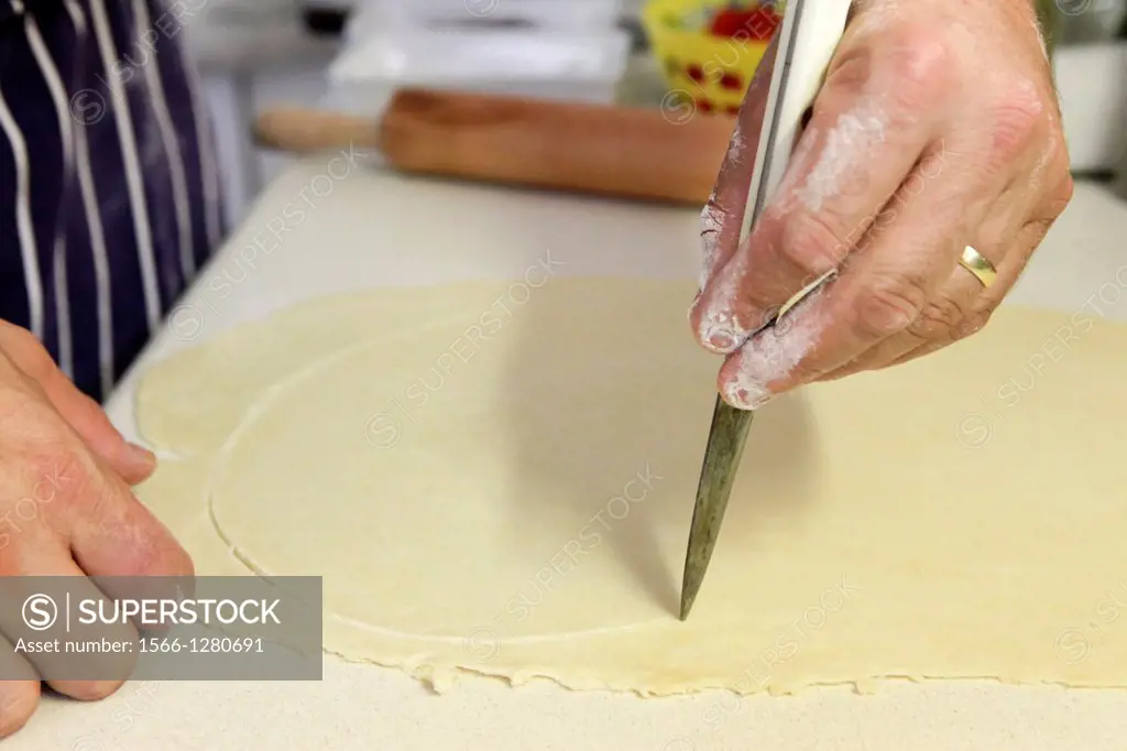home made Cheese Focaccia cutting the dough into shape.