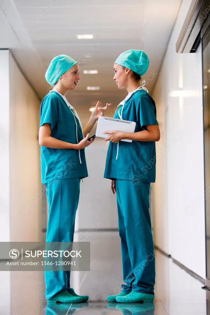 Surgeons with tablet in the operating room hallway, Onkologikoa Hospital, Oncology Institute, Case Center for prevention, diagnosis and treatment of c...