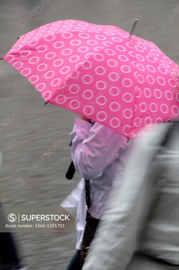 woman with umbrella in street in rome italy