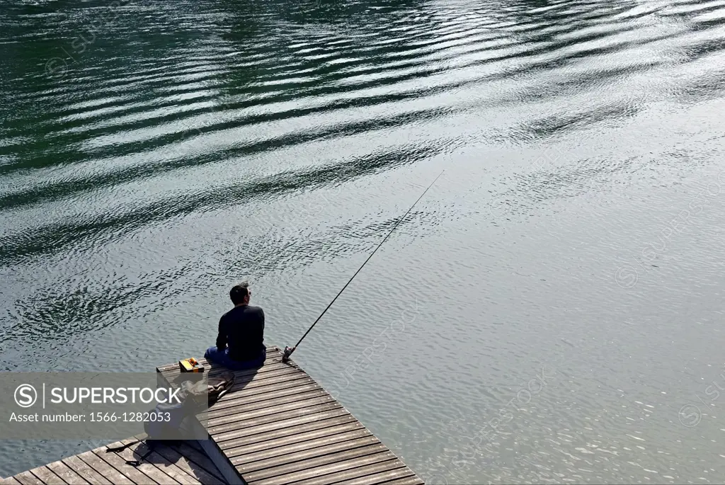 single man fishing with a rod, Rhone river, Geneva, Switzerland
