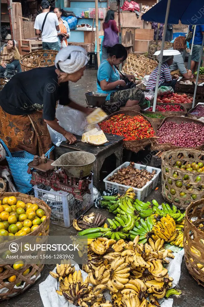 Woman selling fruit and vegetables, at the market in Ubud, Bali, Indonesia.
